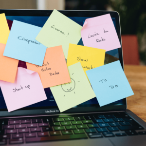 Des post it multicolores sont collés sur un écran d'ordinateur. On peut y lire des mots clés du monde de l'entrepreneuriat : start up, franchise, DIP, entrepreneur, licorne, levée de fonds, slow working, to do...