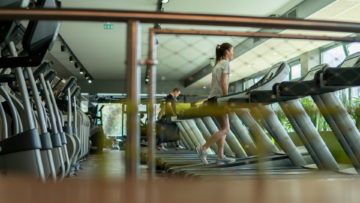 Dans une salle de sport Keep Cool, des personnes marchent sur des tapis de course.