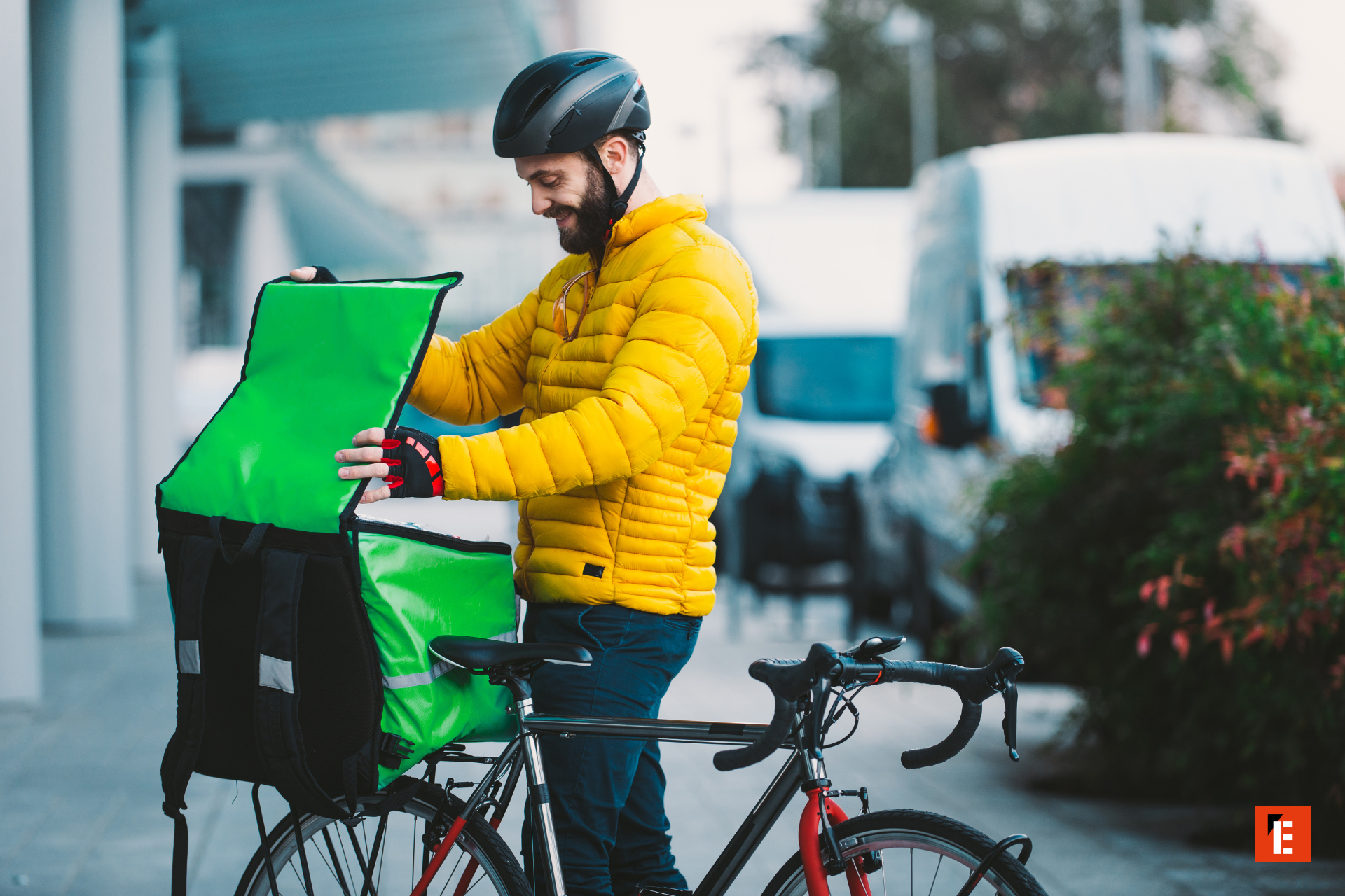 Delivery person preparing food on their bicycle.