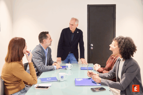 Pareja sonriente sentada en un sofá elegante.