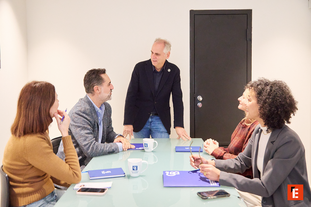 Pareja sonriente sentada en un sofá elegante.