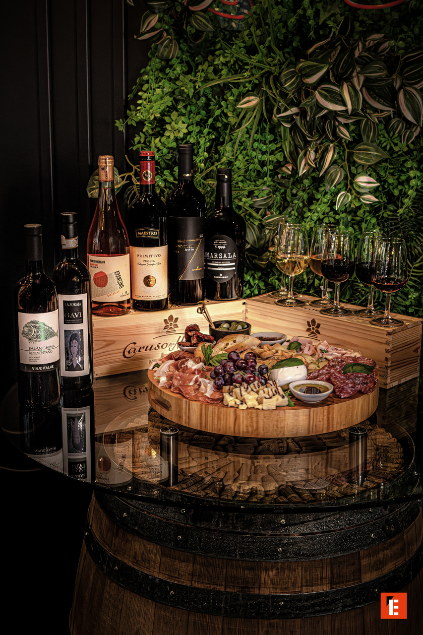 charcuterie board with wine bottles