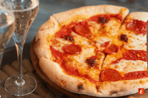 Pizza with pepperoni and two glasses of wine.