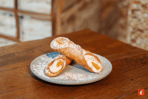 Delicious cannoli on a grey plate.