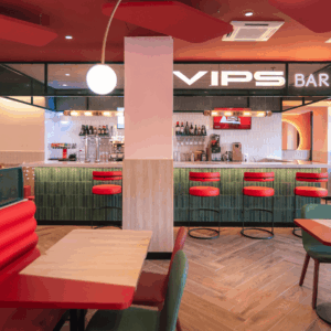 Interior moderno de un bar con asientos coloridos.