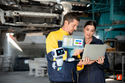 Techniciens discutant avec un ordinateur portable en atelier.