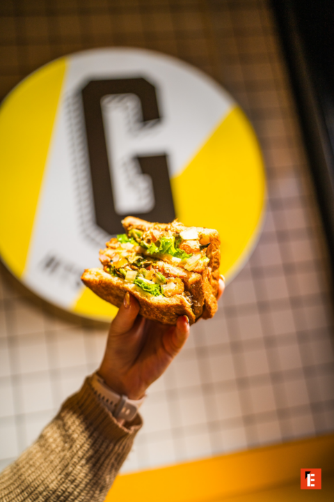 handheld golden toasted sandwich with crispy filling