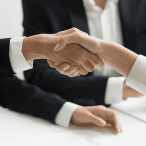 close up of the arms of two people shaking hands