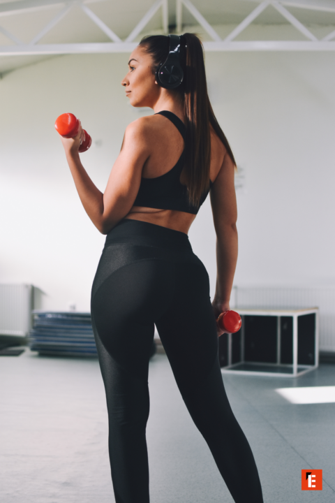 female boxer training on punching bag close up