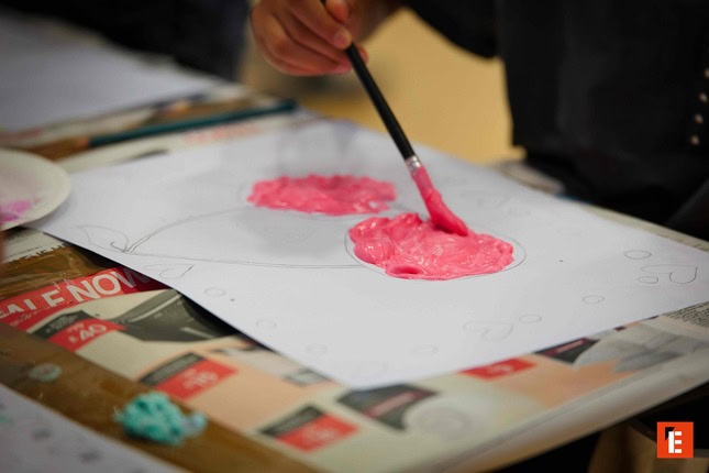 child crafting colourful modelling clay shapes