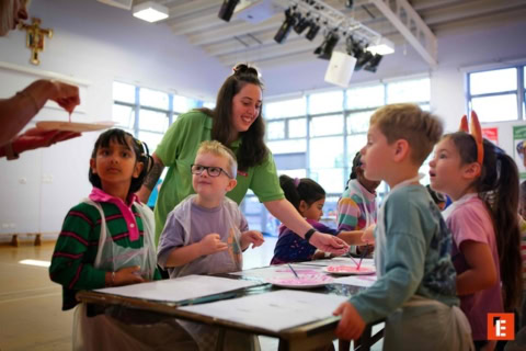 school gym action: child throwing red ball