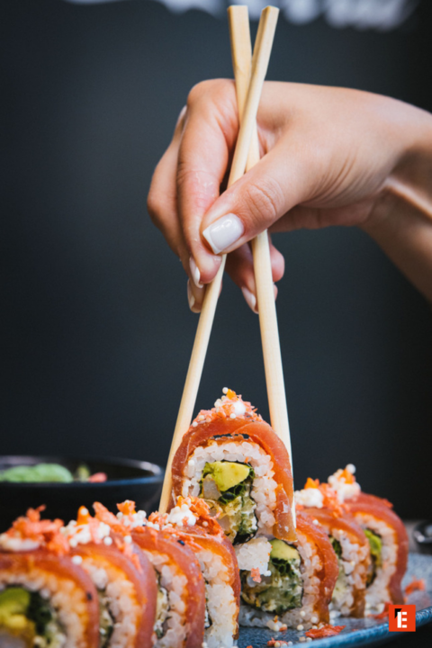 szef kuchni przygotowuje rolki sushi