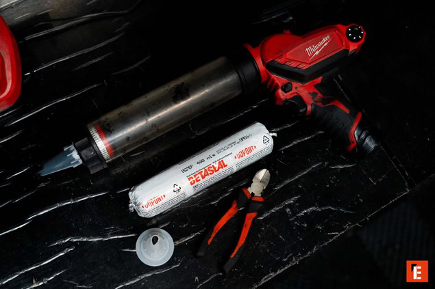 technicien appliquant un apprêt sur pare brise