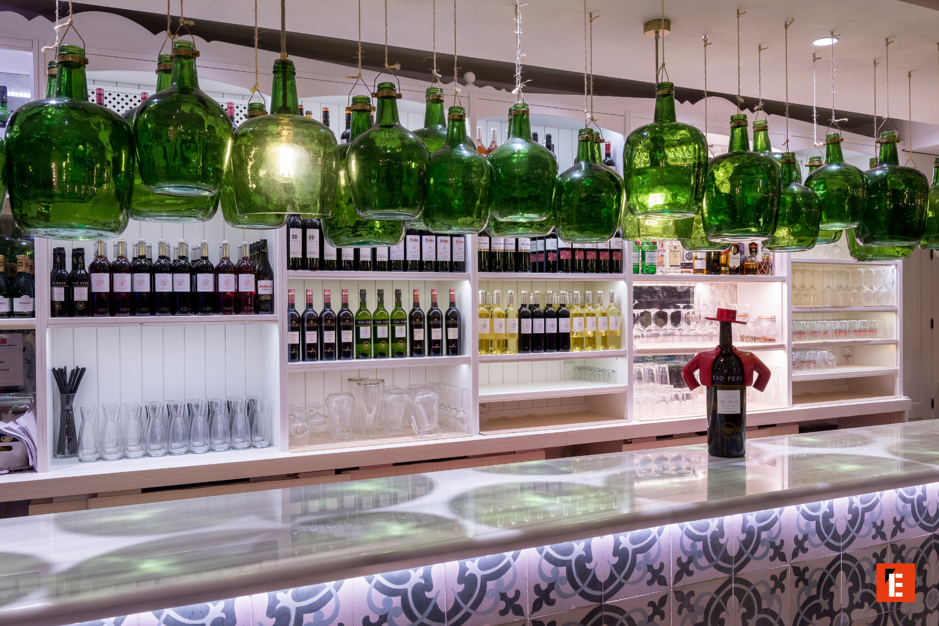 bar moderno con botellas verdes y luces cálidas