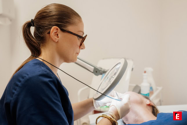 femme souriante appliquant une crème soin visage