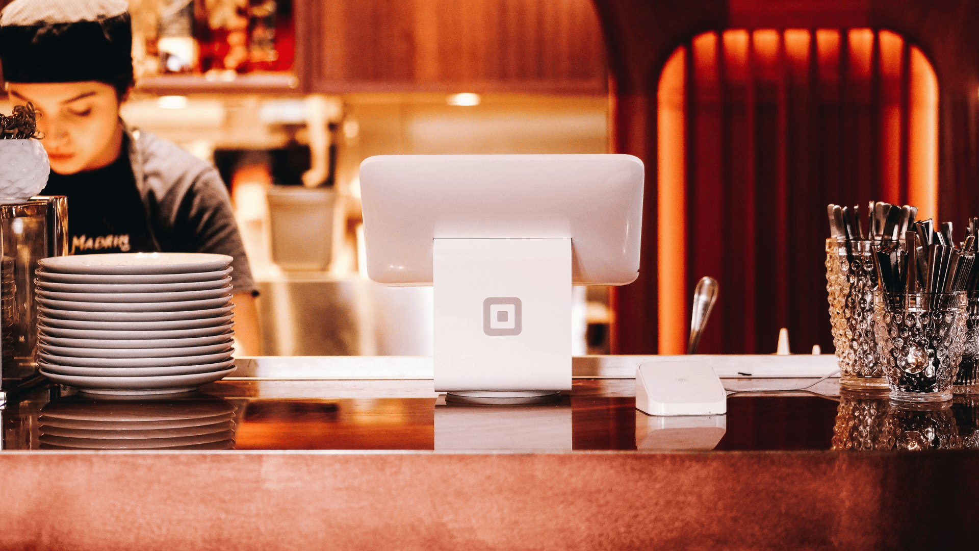 restaurant counter with a lady restaurant worker on the left side