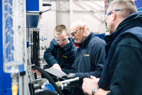 engineers reviewing blueprint in industrial plant