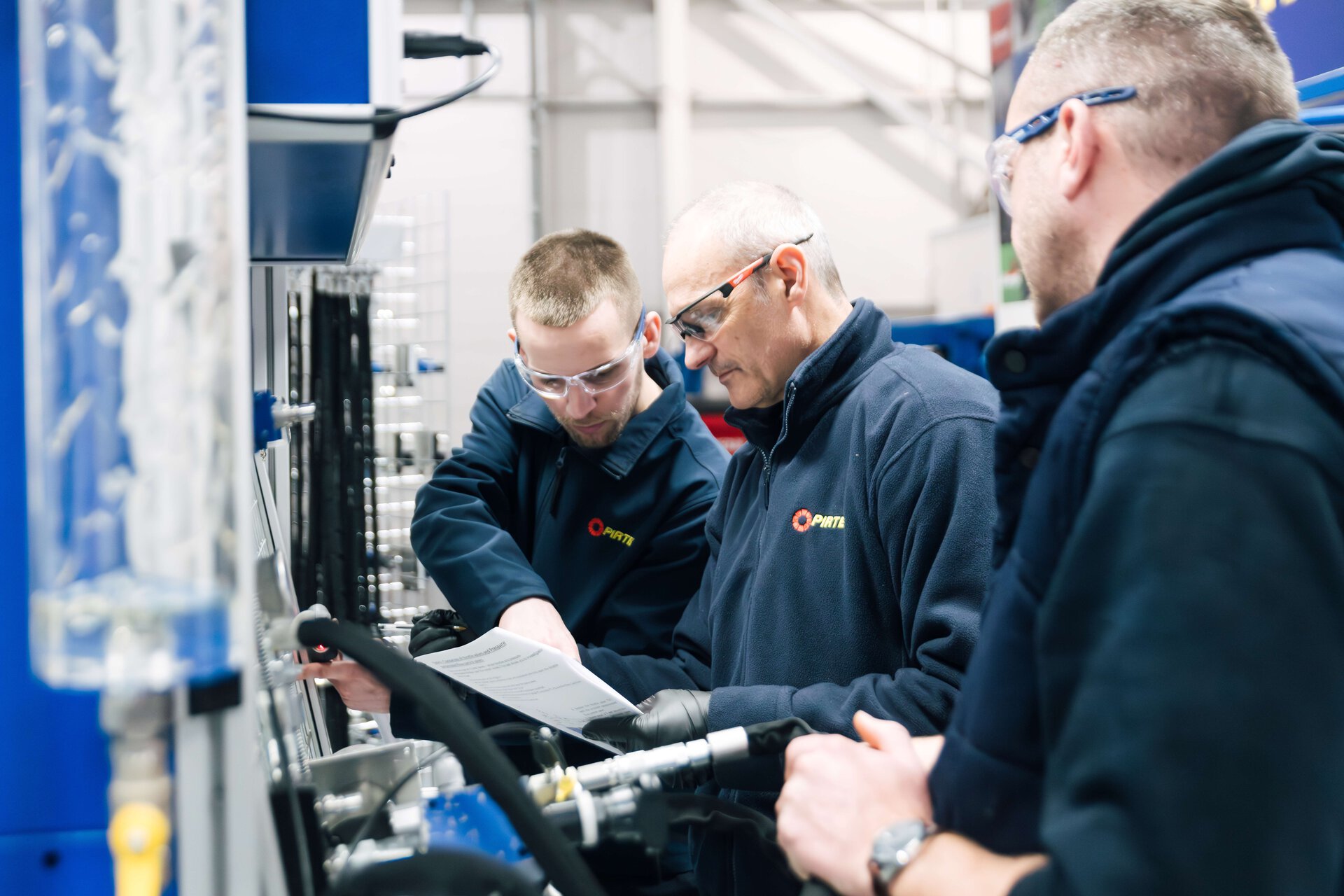 engineers reviewing blueprint in industrial plant