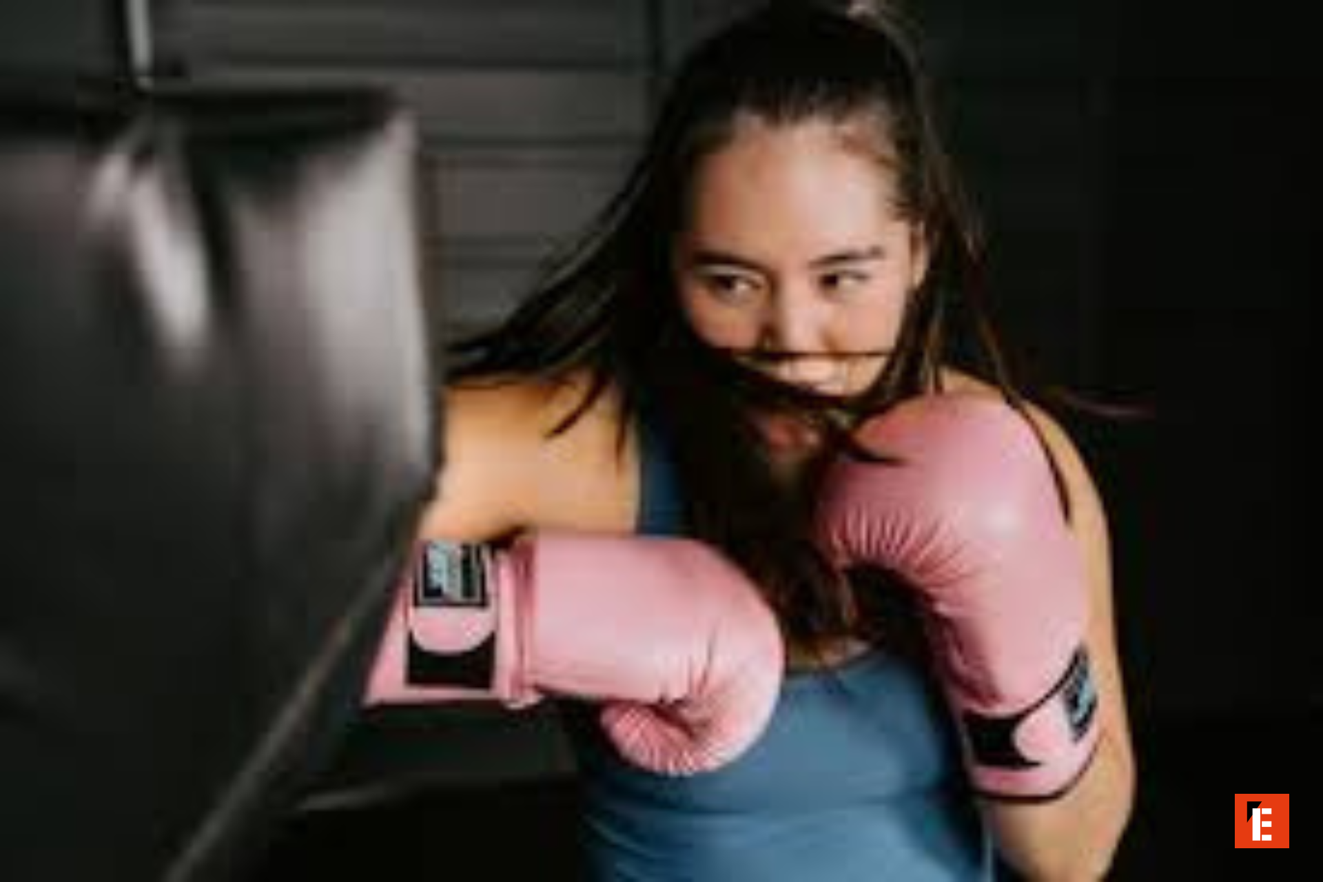 female boxer training with pink gloves