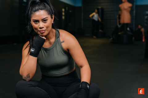female boxer resting between training rounds