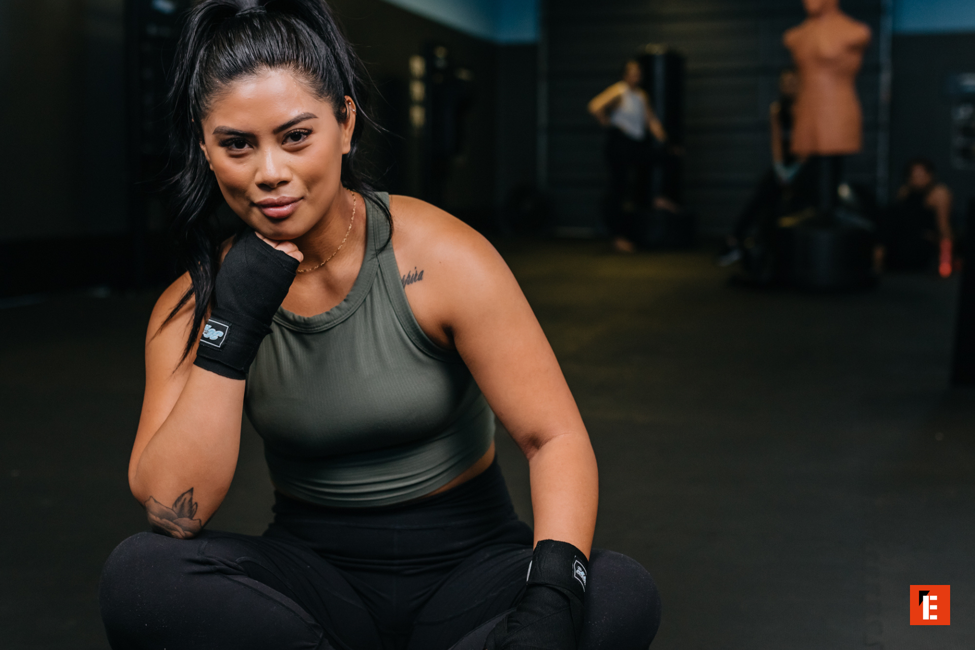 female boxer resting between training rounds