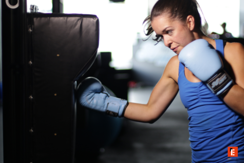 female boxer training with blue gloves