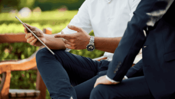 close up on two business men discussing a project