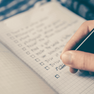 handwritten checklist on graph paper notebook