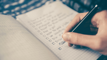handwritten checklist on graph paper notebook
