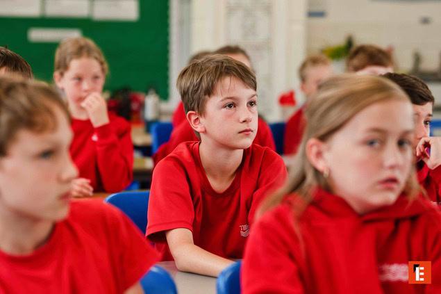 attentive schoolboy among classroom pupils