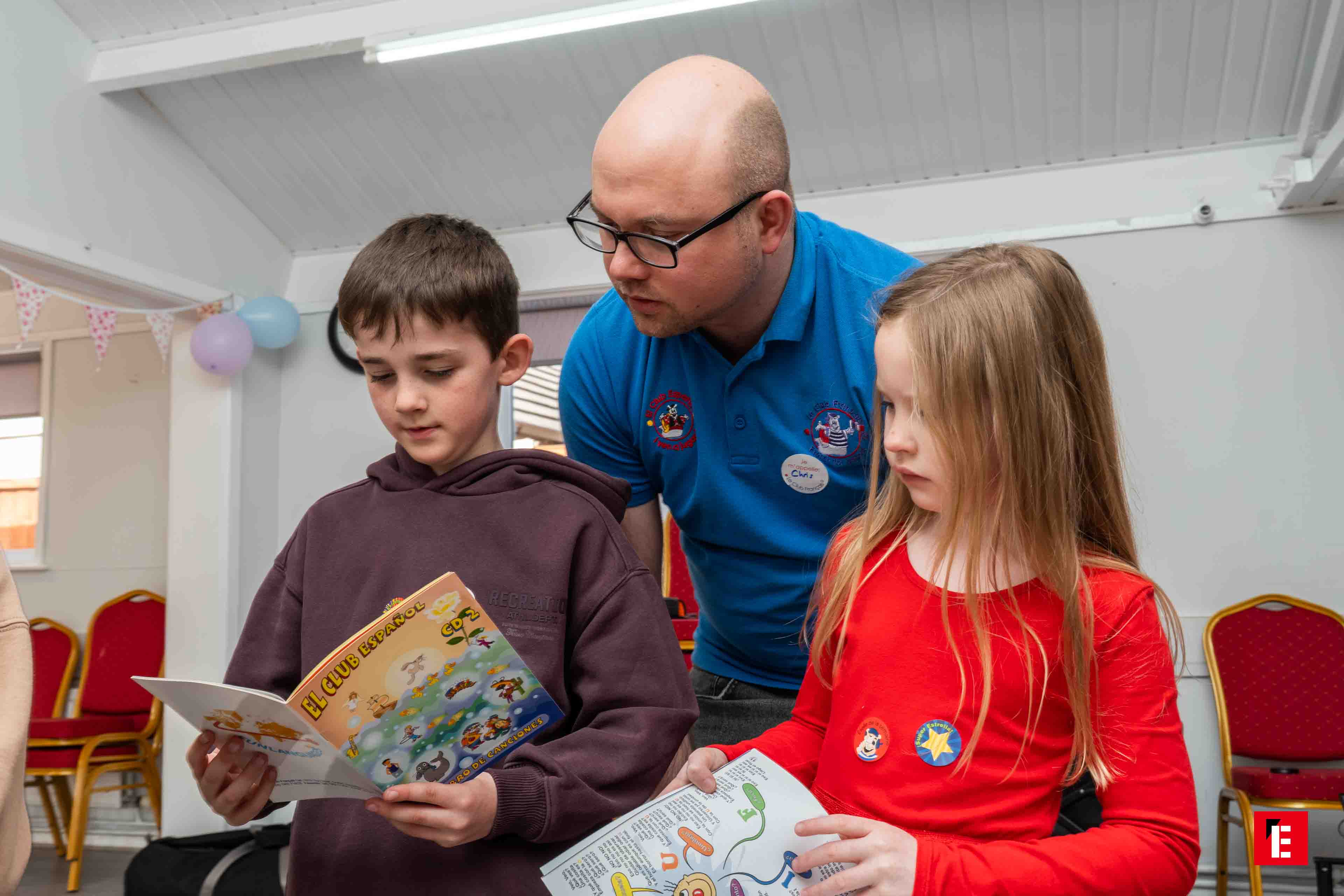 adult guiding children with spanish activity book