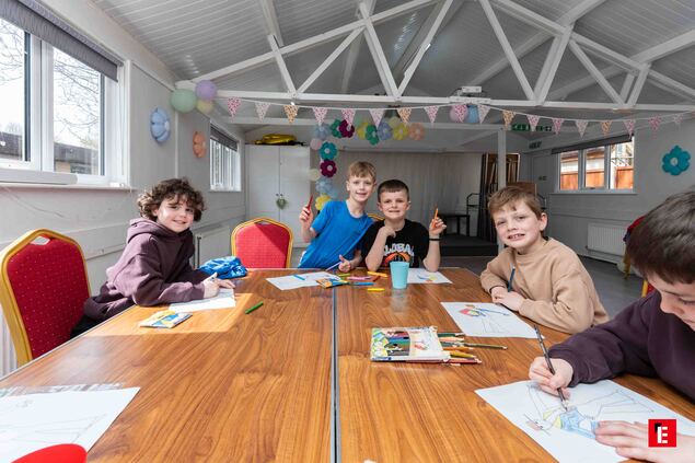 children coloring and crafting in bright workshop