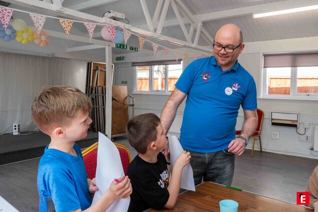 kids craft workshop with teacher in community room