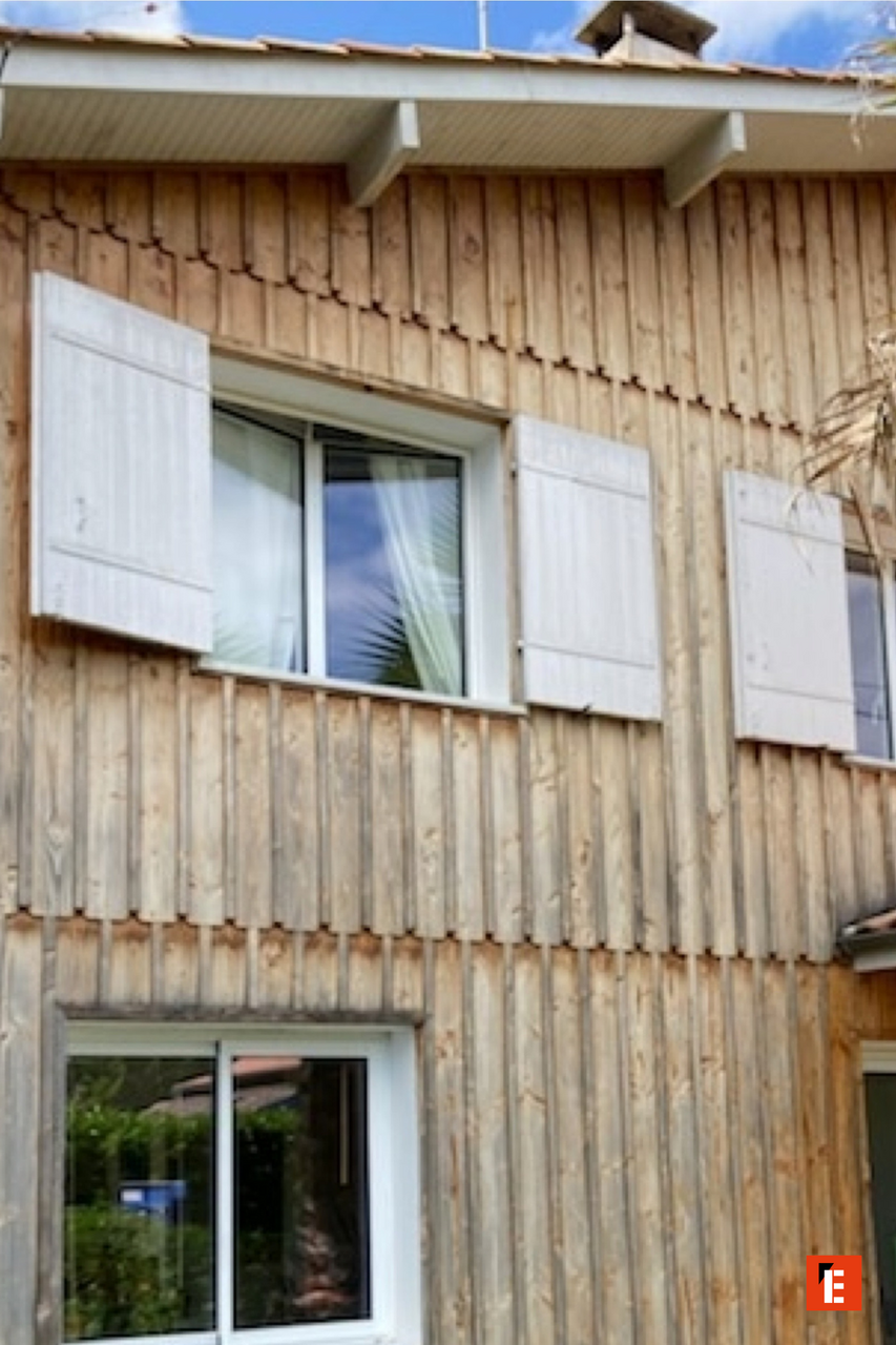 façade en bois avec fenêtres et volets ouverts