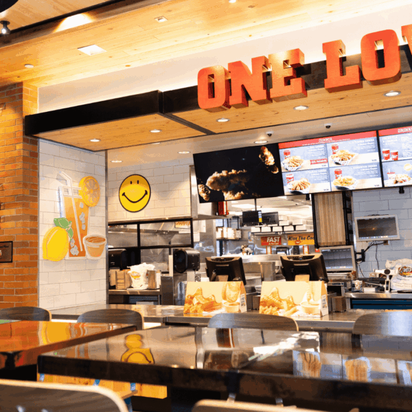 raising canes bright interior with one love mural
