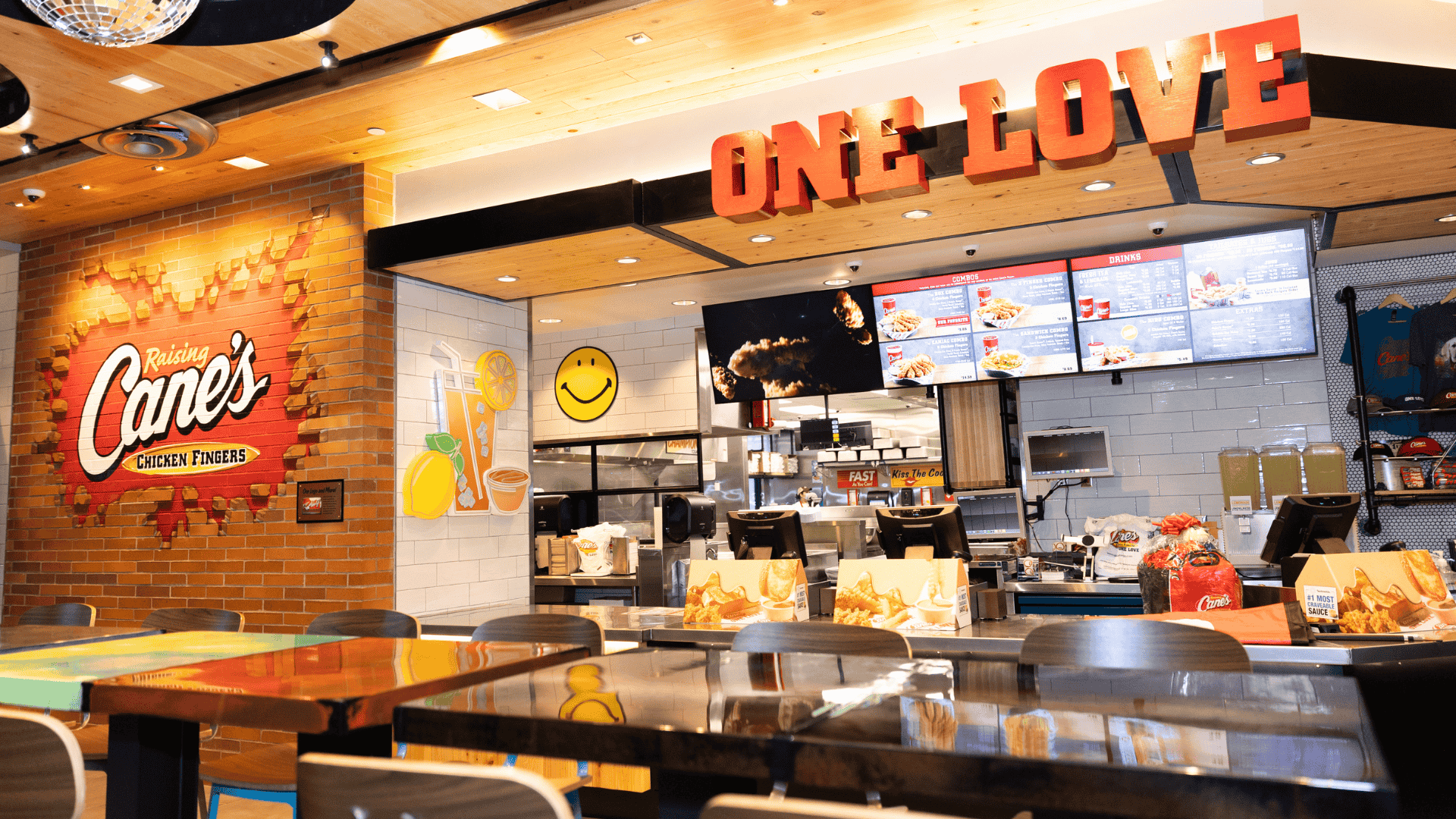 raising canes bright interior with one love mural