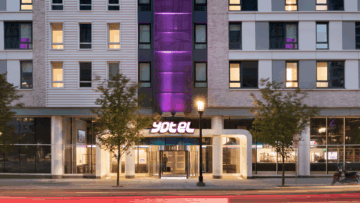 yotel 65 hotel exterior at dusk with purple lighting