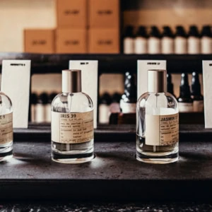 bottiglie di profumo artigianali minimaliste su ripiano vintage