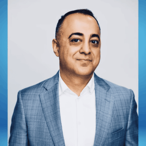 executive headshot: man in gray checked blazer