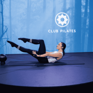club pilates teaser pose in forest studio