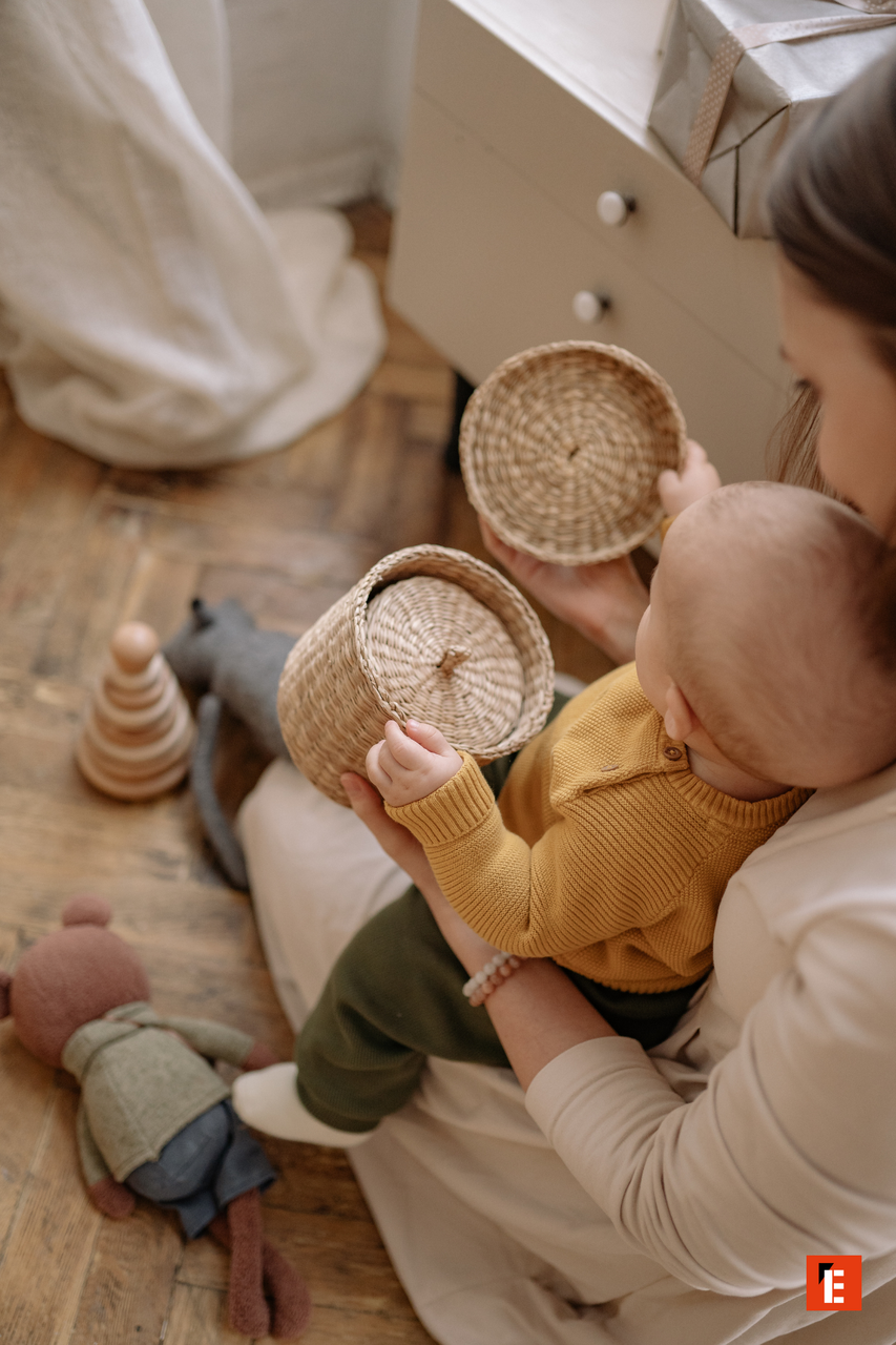 moment tendre: bébé sur les genoux avec panier en rotin