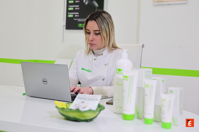 estetista con computer e prodotti per la pelle