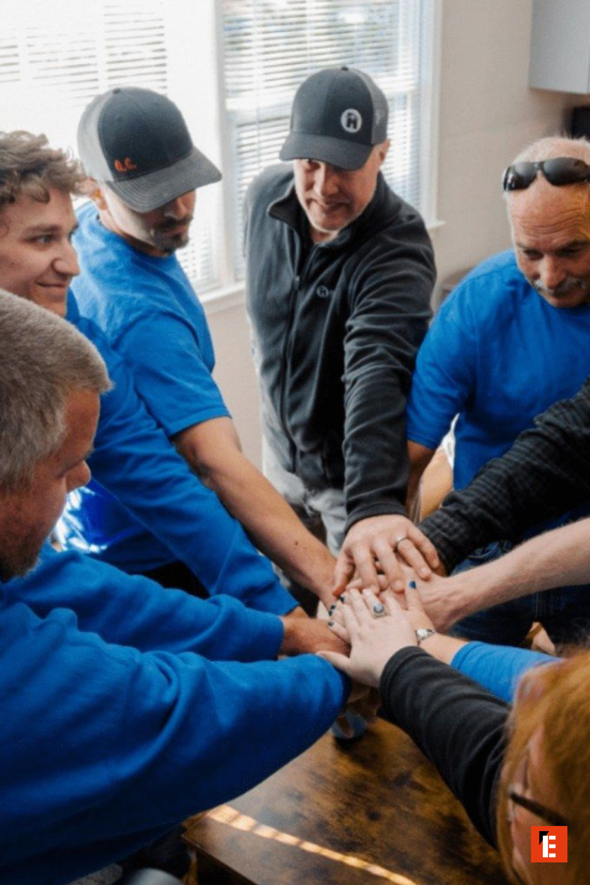 team huddle: hands united in blue