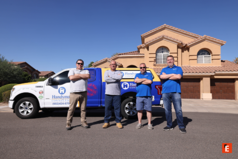 handyman team with branded truck at suburban home