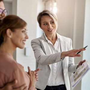 maklerin zeigt grundriss bei wohnungsbesichtigung