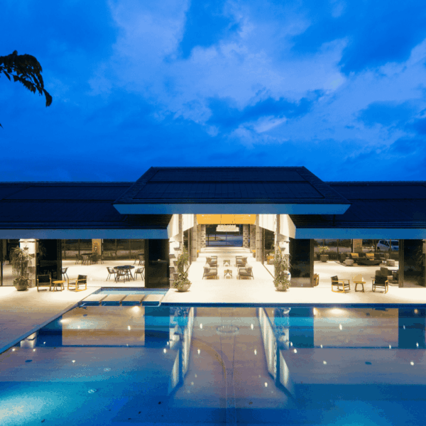 modern pool pavilion at twilight with glass facade