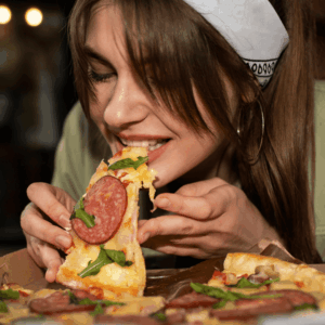 disfrutando pizza con queso fundido y rúcula