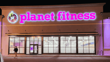 planet fitness neon storefront at night
