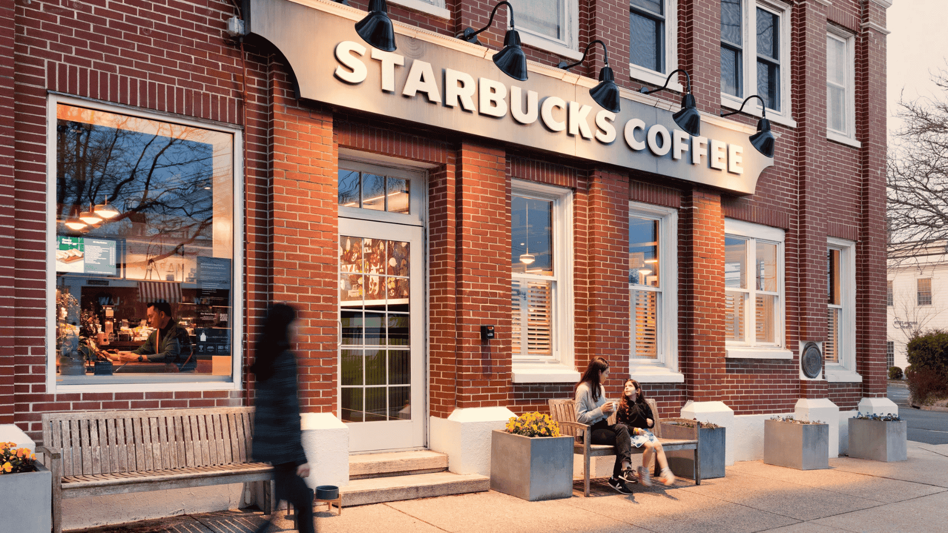 cozy neighborhood starbucks storefront in brick building