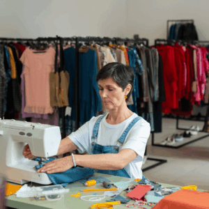 costurera reparando vaquero en tienda de segunda mano